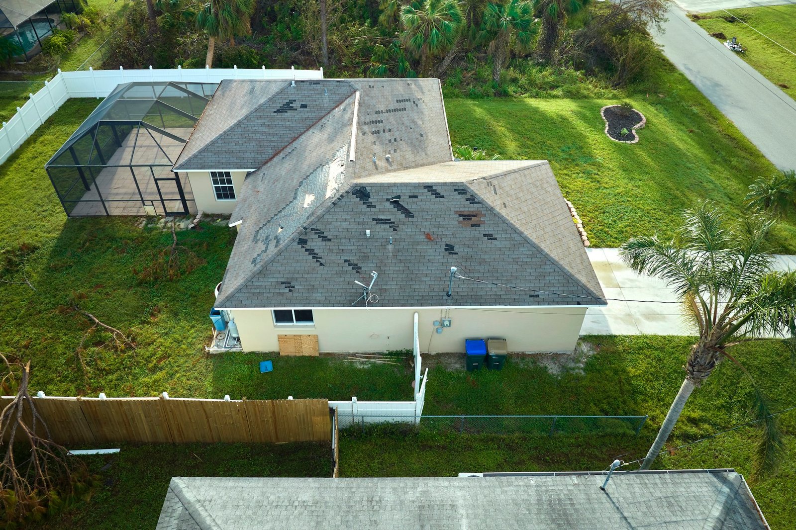 Hurricane Ian destroyed house roof in Florida residential area.